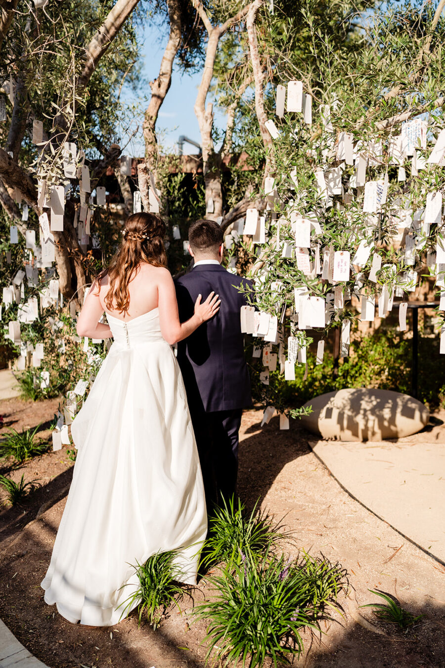 bride and groom in front of letter tree at Estancia La Jolla