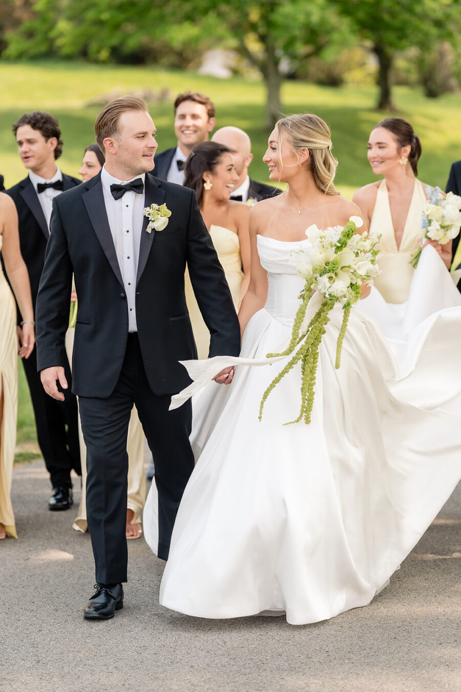 bride and groom walking with wedding party at their Diamond Creek Farms wedding in Nashville