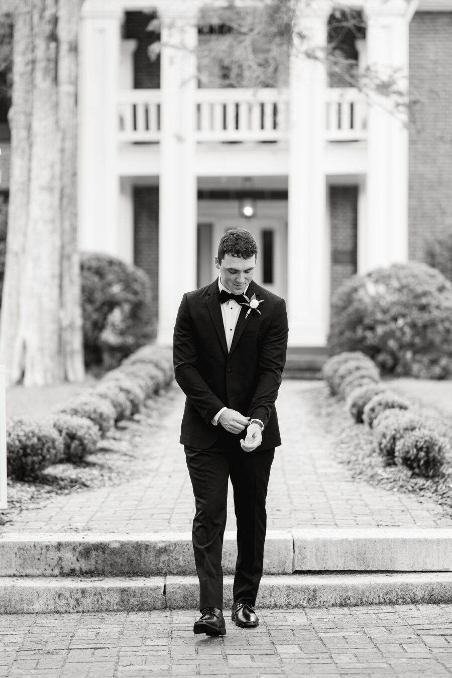 Groom walking away adjusting his sleeves at his wedding in Franklin TN