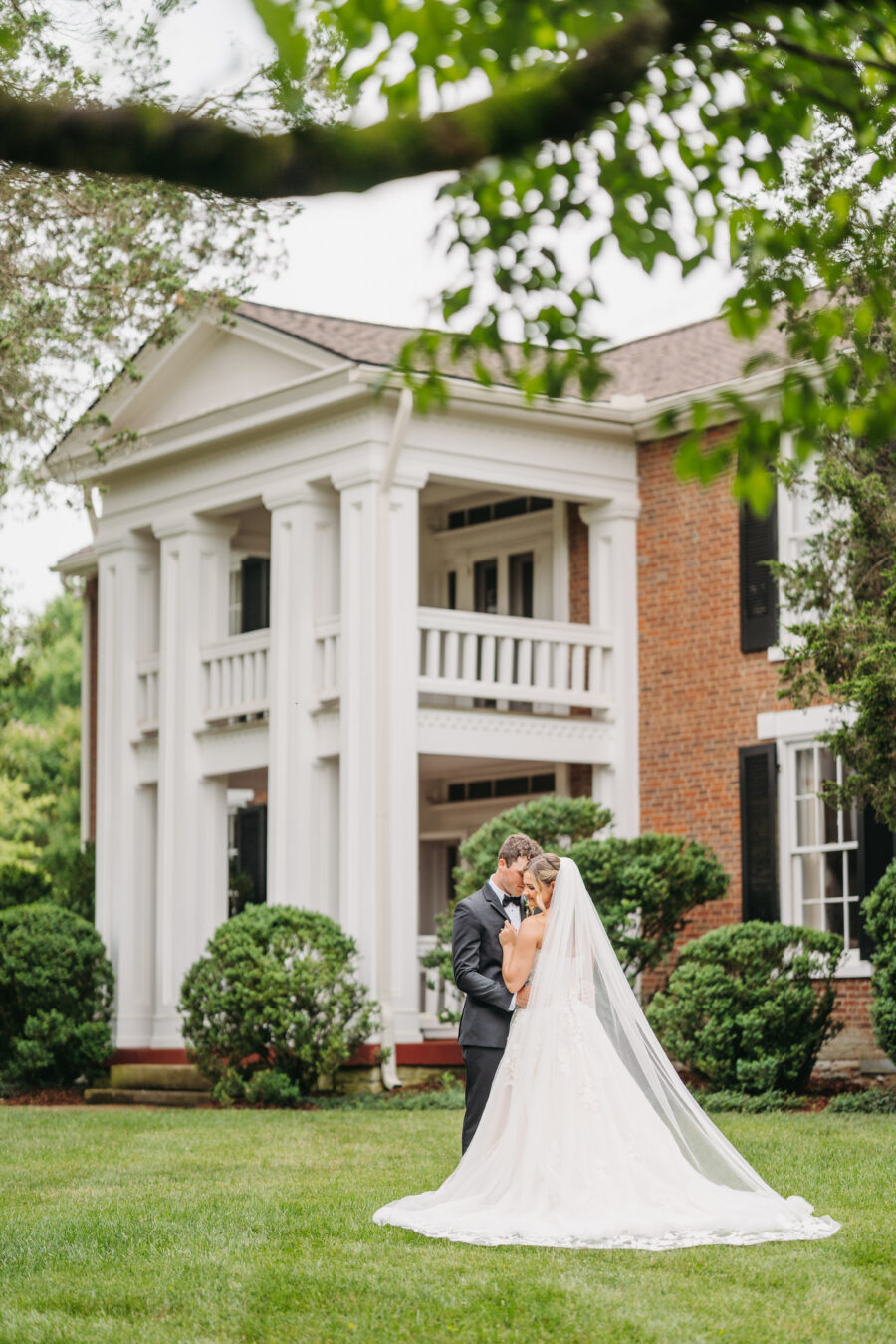 Bride and groom in front of the mansion at Cedarmont Farms