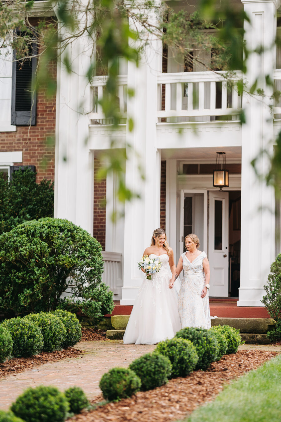 Bride walking down the aisle with her mom at her wedding in Franklin, TN