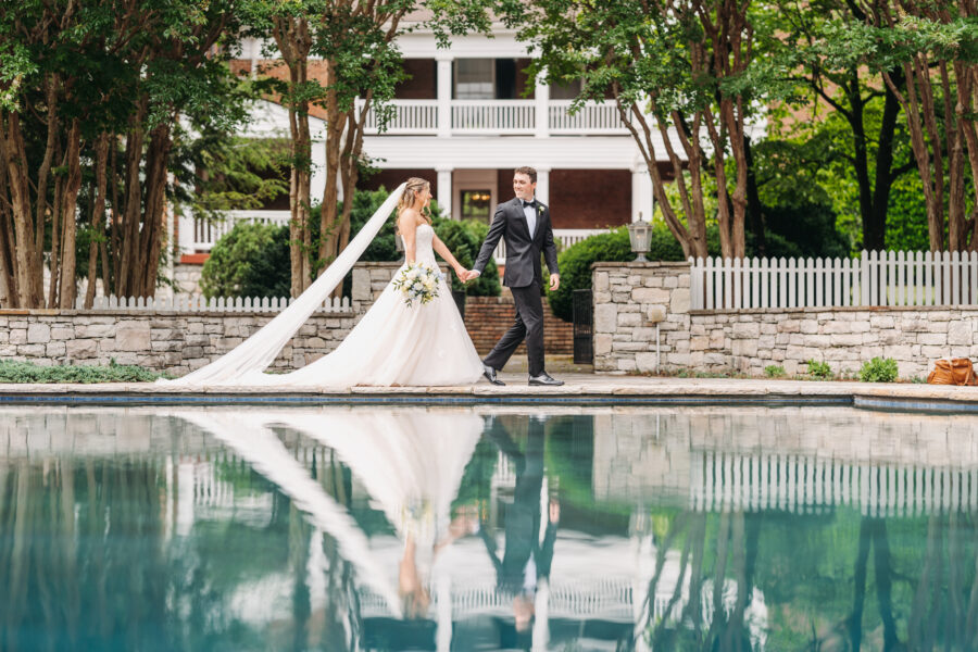 Bride and Groom walking by the pool at Cedarmont Farms
