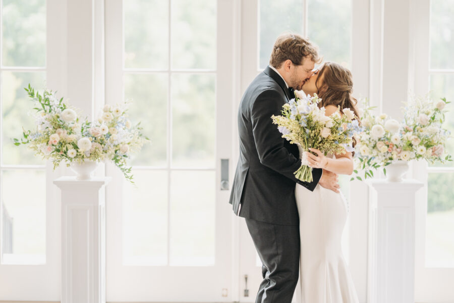Bride and Groom kissing at their ceremony site at The Venue at Birchwood.