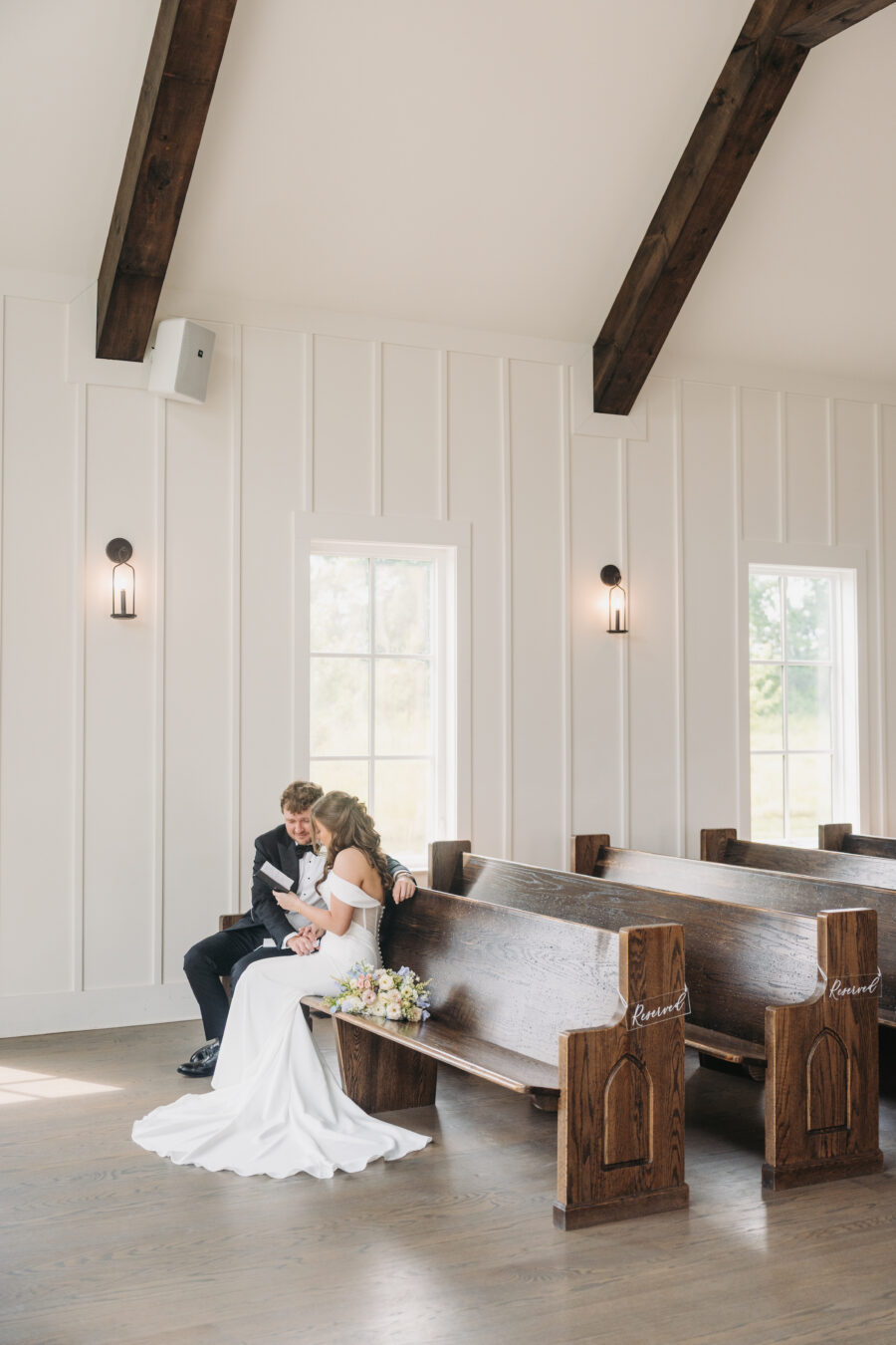 A bride and groom sharing their vows in a chapel.