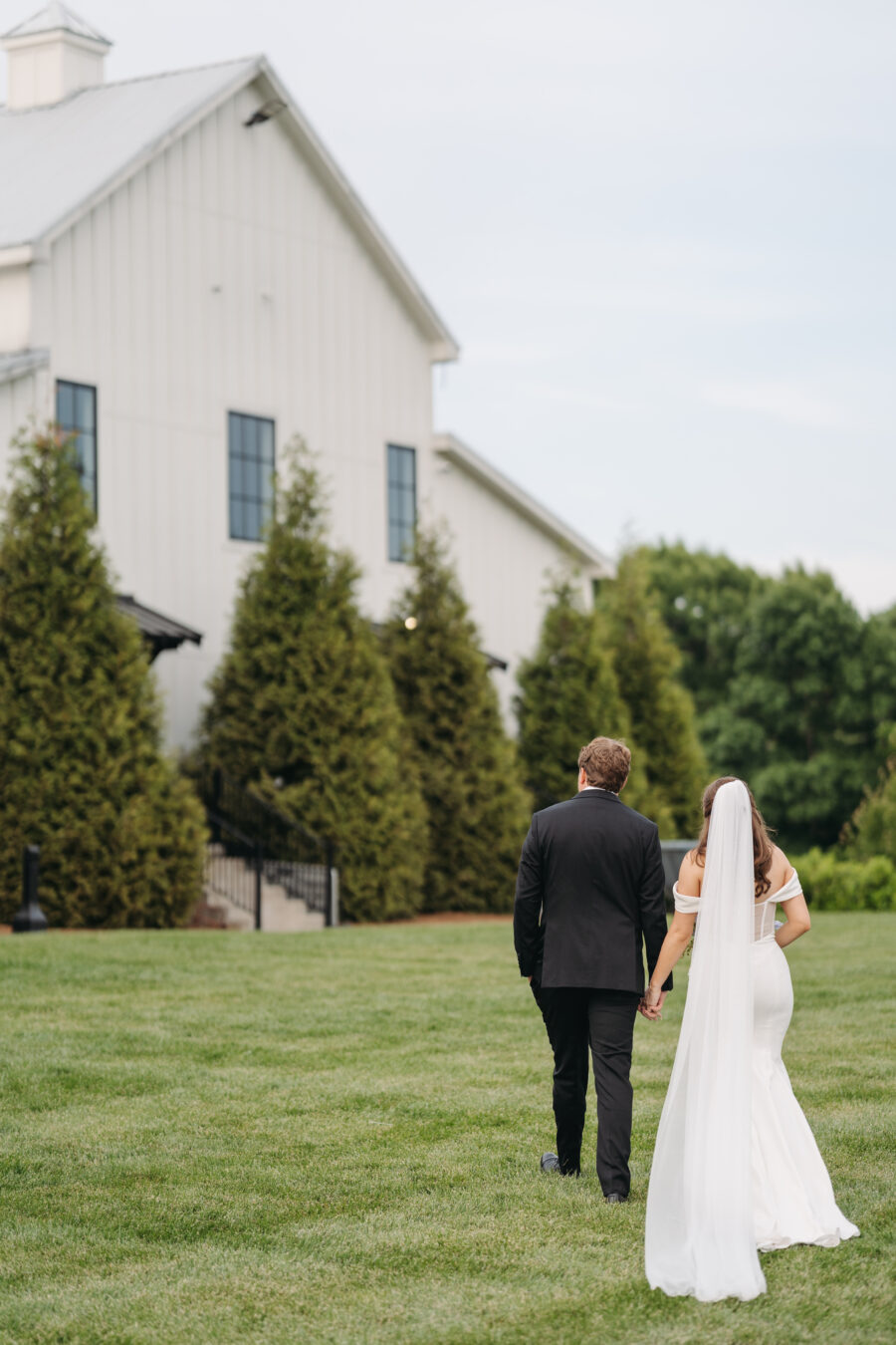 A bride and groom walking away at their wedding
